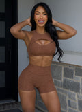 front profile view of a model in outdoors wearing the V Back Shorts in Coffee Bean color