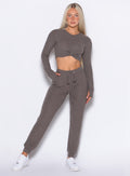 front profile view of a model with one hand inside the pocket wearing the Cuddle Up Joggers in Cozy chocolate color