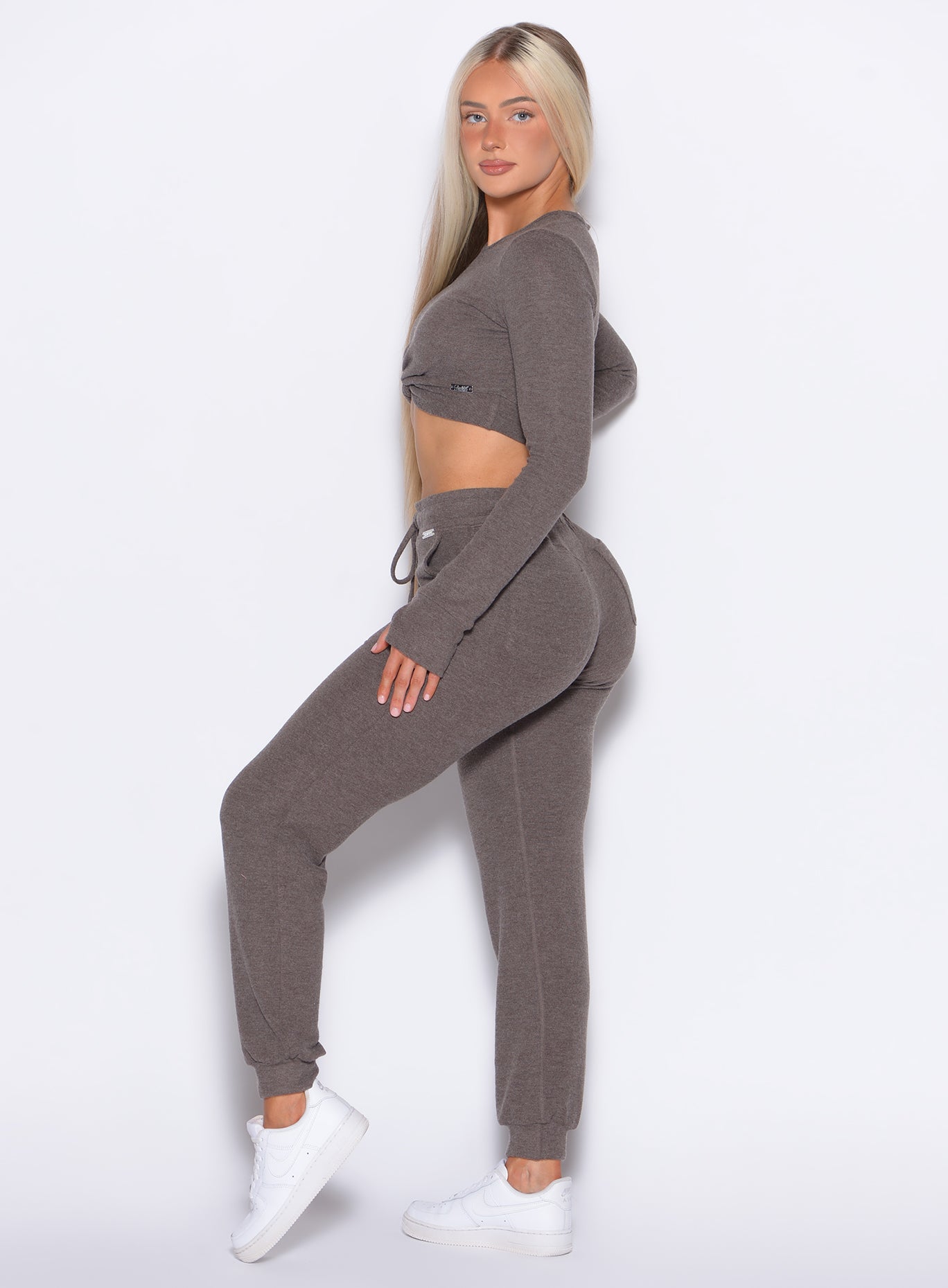 left side profile view of a model wearing the Cuddle Up Joggers in Cozy chocolate color