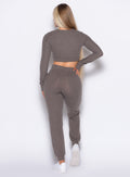 back profile view of a model with one hand on her waist wearing the Cuddle Up Joggers in Cozy chocolate color