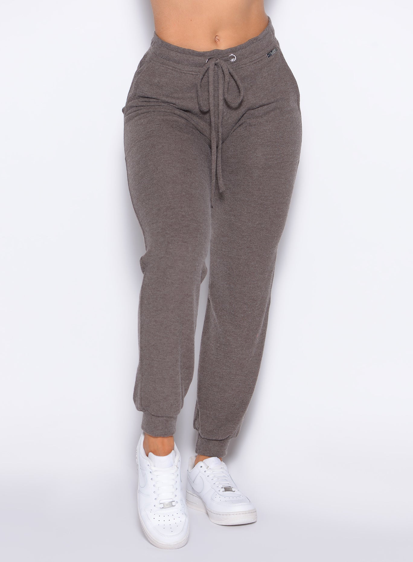 close up front profile view of a model wearing the Cuddle Up Joggers in Cozy chocolate color