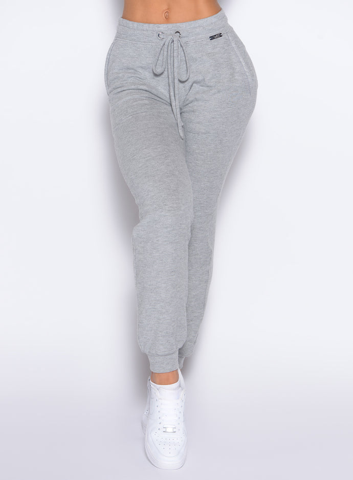 close up front profile view of a model wearing the Cuddle Up Joggers in Cozy Silver color