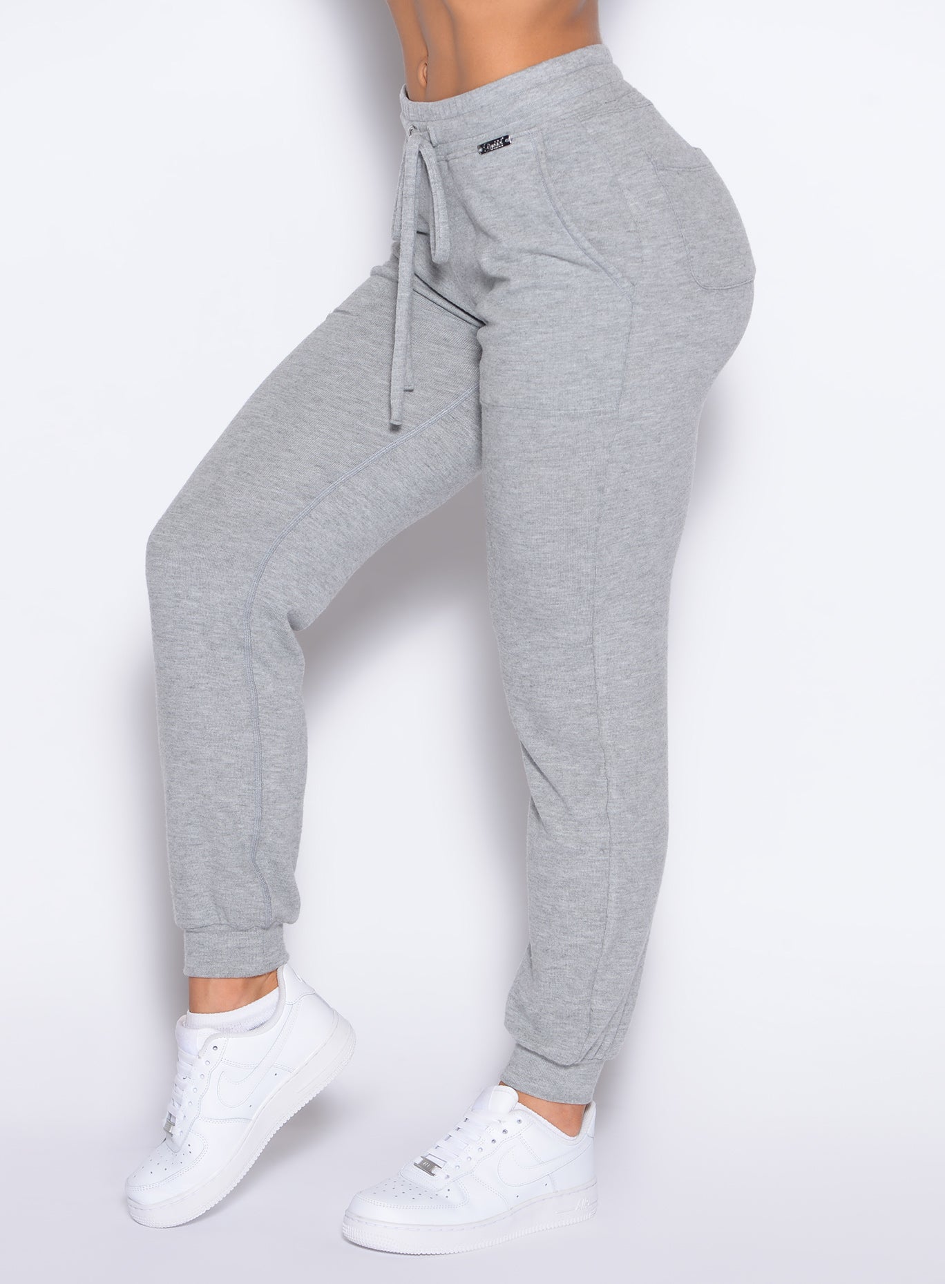 close up left side profile view of a model wearing the Cuddle Up Joggers in Cozy Silver color