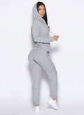 right side profile view of a model wearing the Cuddle Up Joggers in Cozy Silver color paired with the matching hoodie