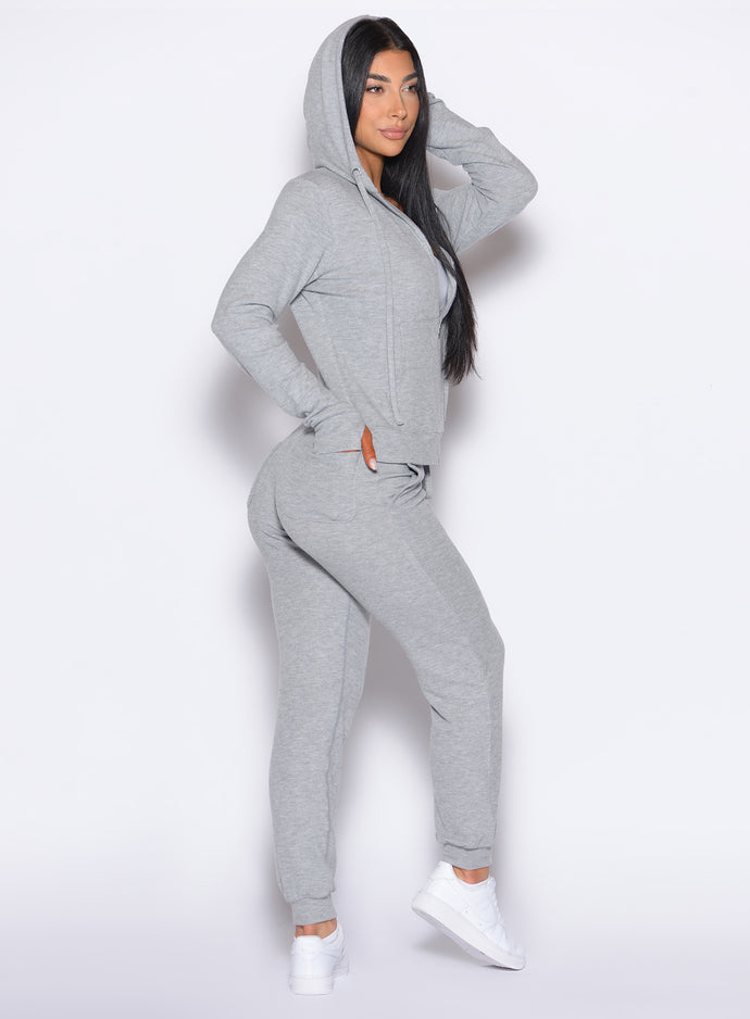 right side profile view of a model with one hand inside the back pocket wearing the Cuddle Up Joggers in Cozy Silver color