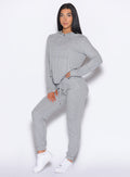 front left side profile view of a model with one hand on her waist wearing the Cuddle Up Joggers in Cozy Silver color