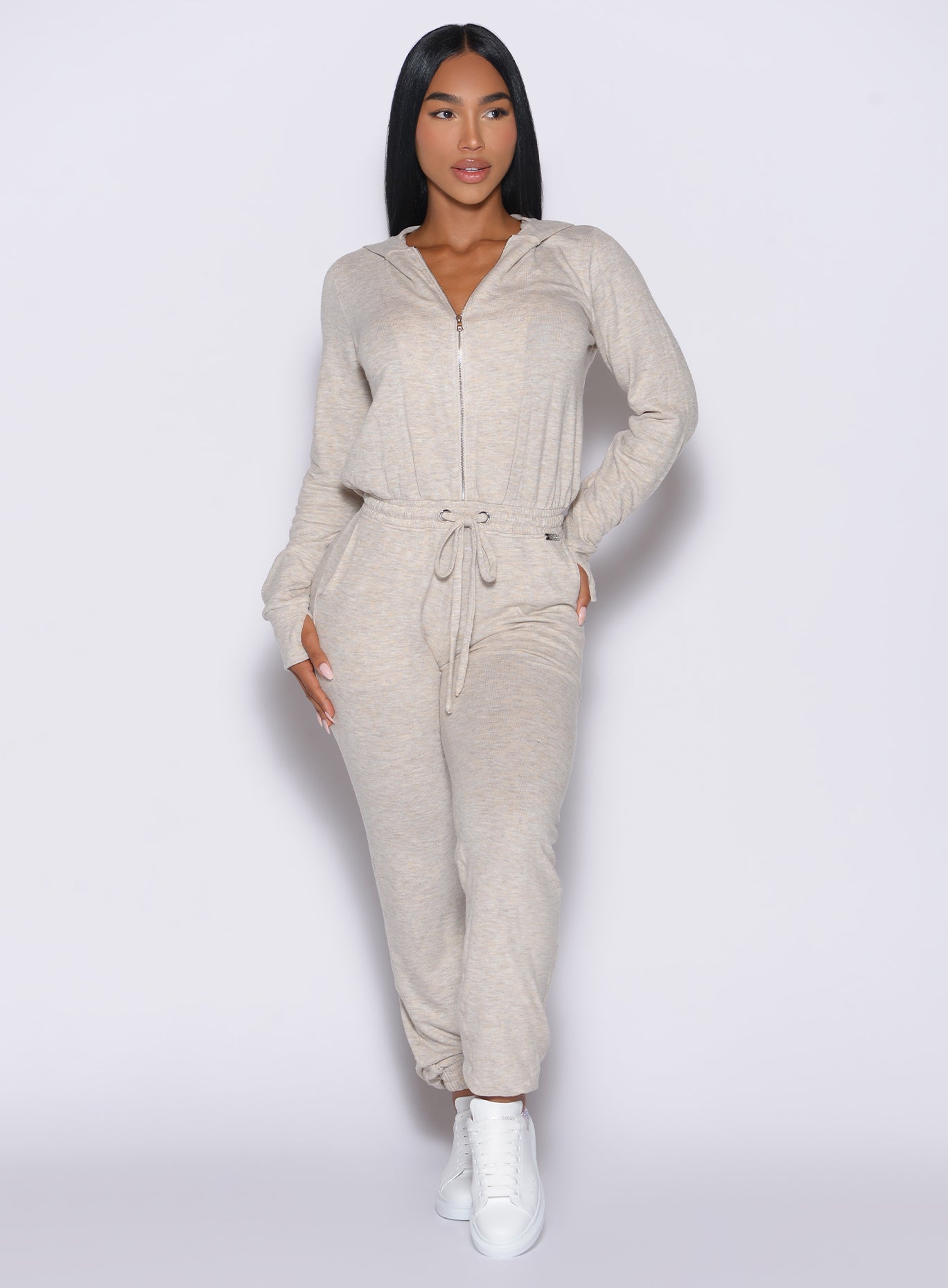 front profile view of model wearing the Flirty Jumpsuit in Cozy oat color