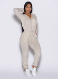 front profile view model with arm up wearing the Flirty Jumpsuit in Cozy oat color