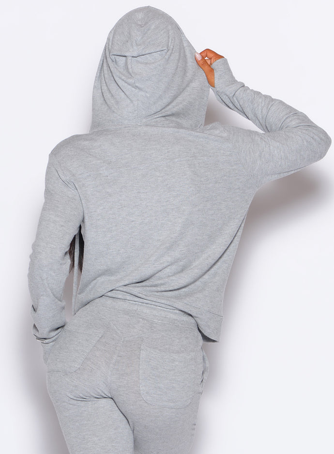 back profile view of a model wearing the Gym Crush Hoodie in Cozy Silver color