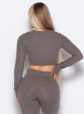 back profile view of a model wearing the Love Knot Pullover in Cozy chocolate color