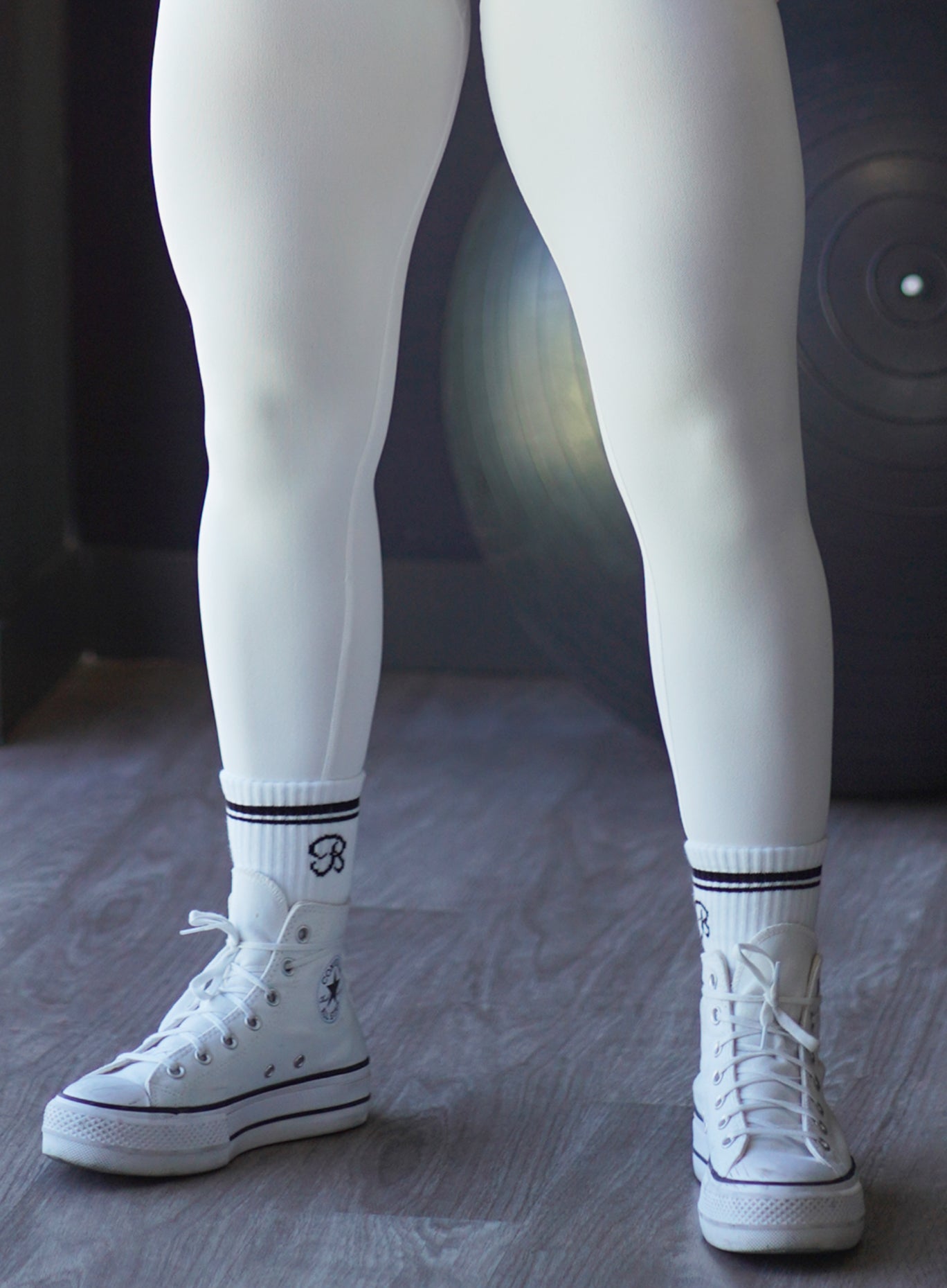 front close up view of model wearing logo B white with black stripe crew socks