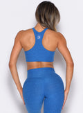 Back side close up view of model wearing the Cross Over Halter Bra and the matching leggings in Royal color