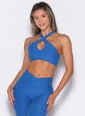 Model facing forward wearing our Cross Over Halter Bra and the matching leggings in Royal color