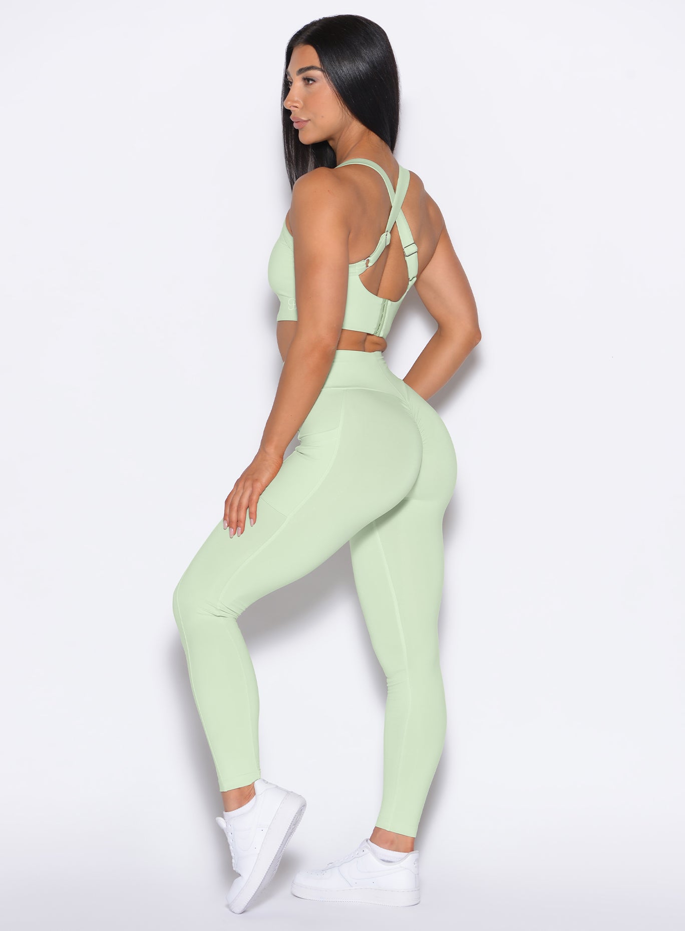 left side profile view of our model wearing the Curves 2.0 Leggings in Cool Matcha color