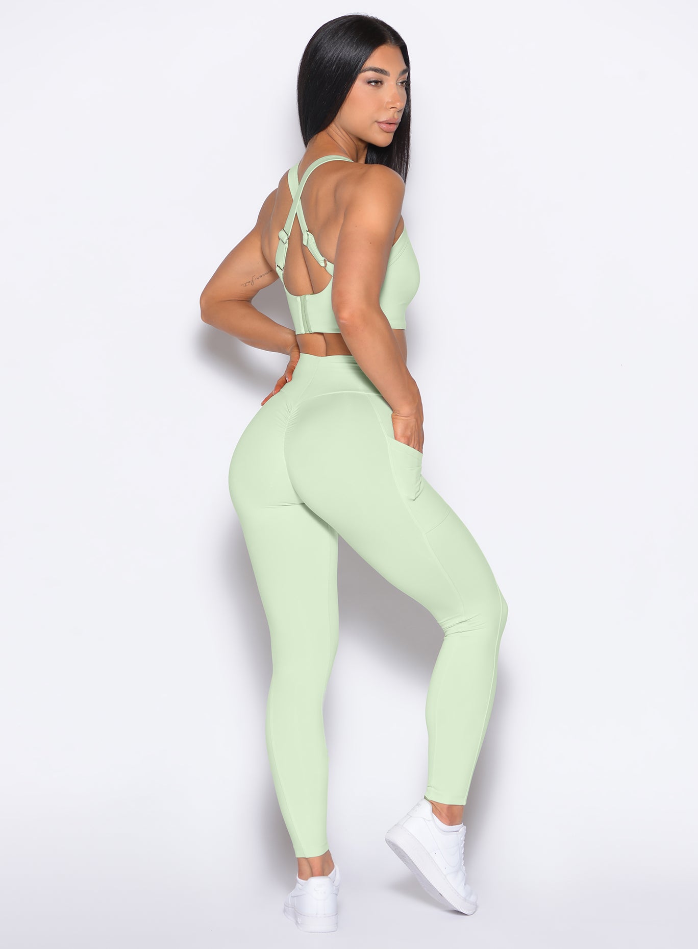 Right side profile view of our model wearing the Curves 2.0 Leggings in Cool Matcha color