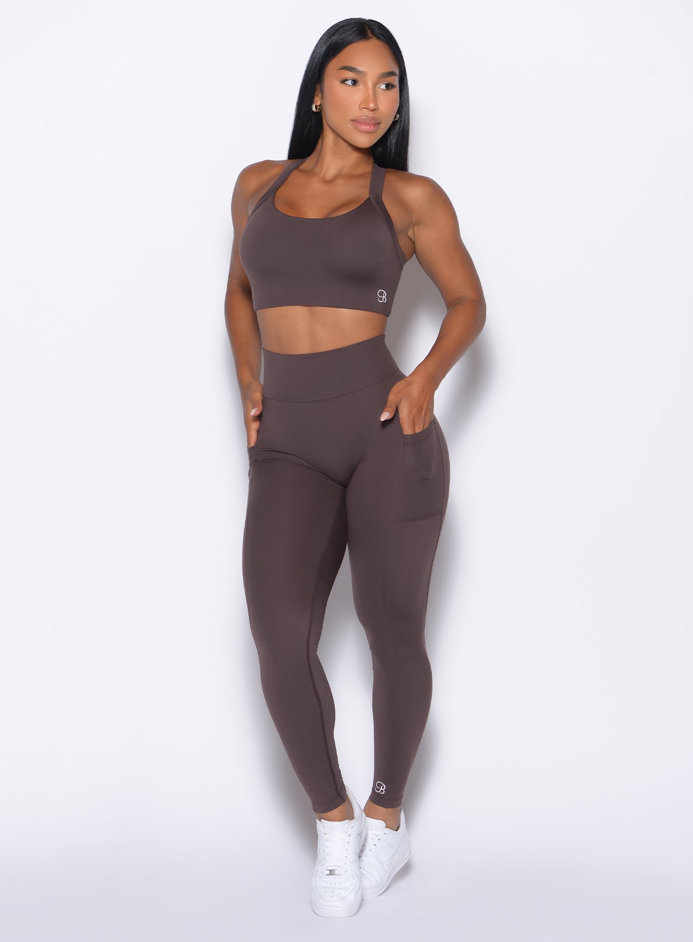 front profile view of our model looking to the left wearing the Curves 2.0 Leggings in Seal Brown color