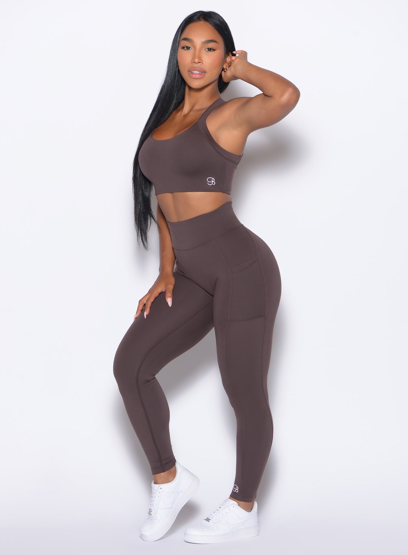 left side profile view of our model wearing the Curves 2.0 Leggings in Seal Brown color