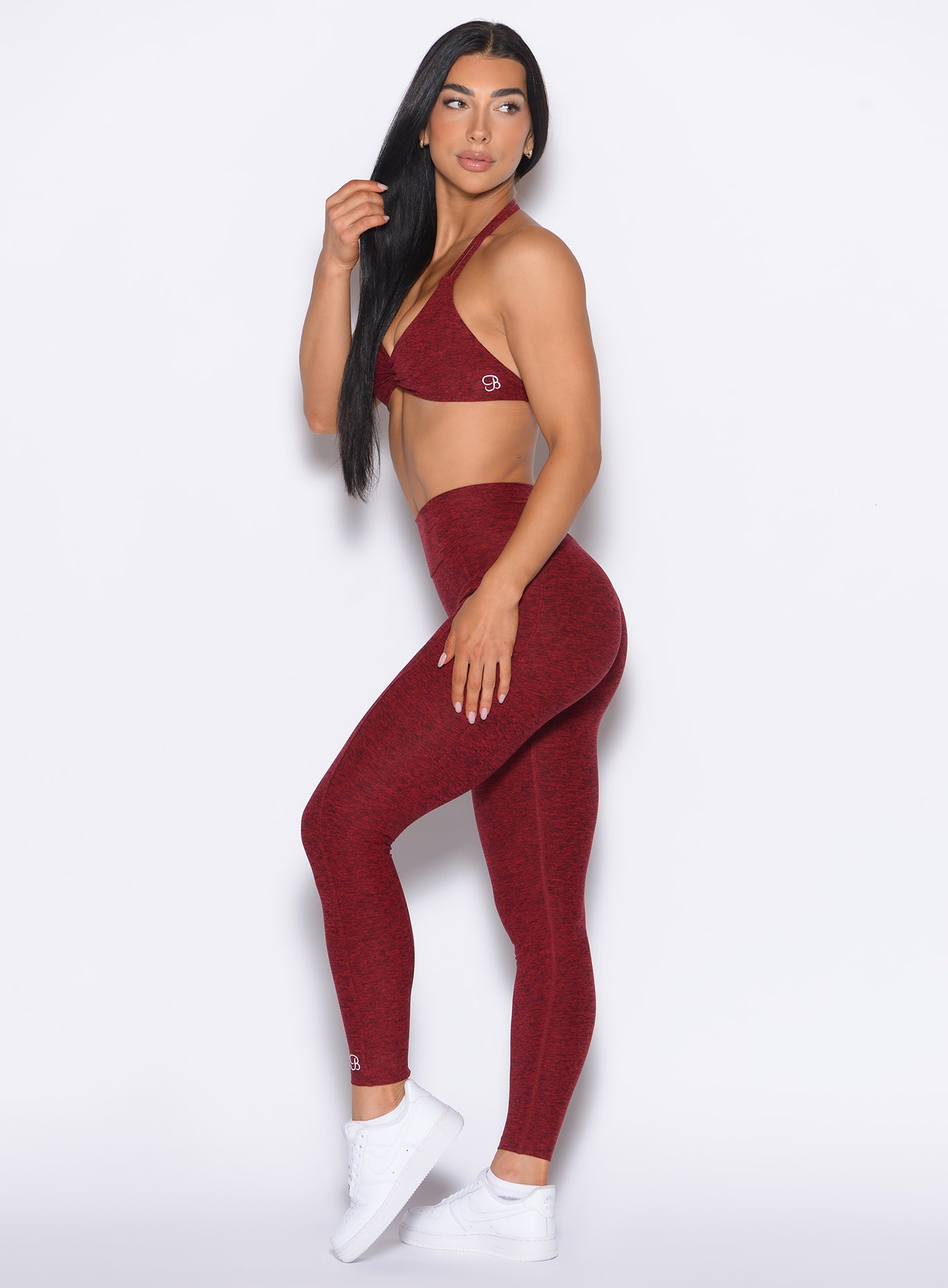 left side profile view of our model wearing the Curves 2.0 Leggings in Black Cherry color