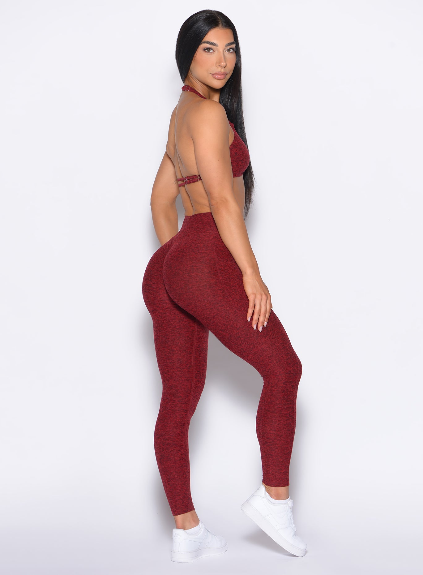 right side profile view of our model looking over her shoulder wearing the Curves 2.0 Leggings in Black Cherry color