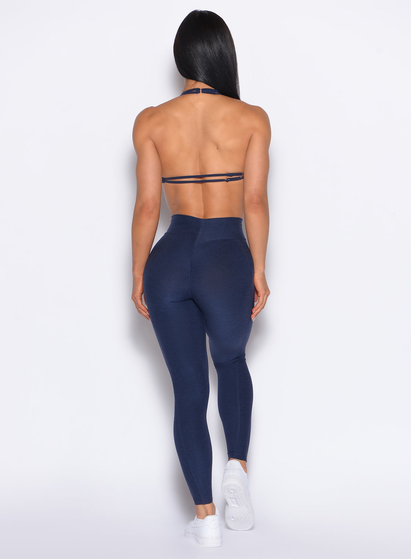 Back profile view of our model wearing the Curves 2.0 Leggings in Cosmic Blue color