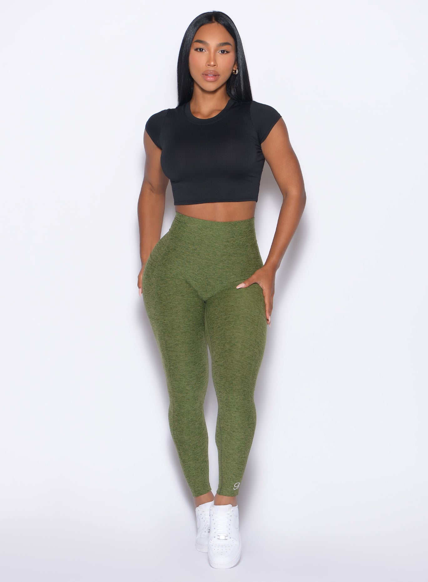 front profile view of our model wearing the Curves 2.0 Leggings in Juniper color paired with the Flex Crop Tee in Black