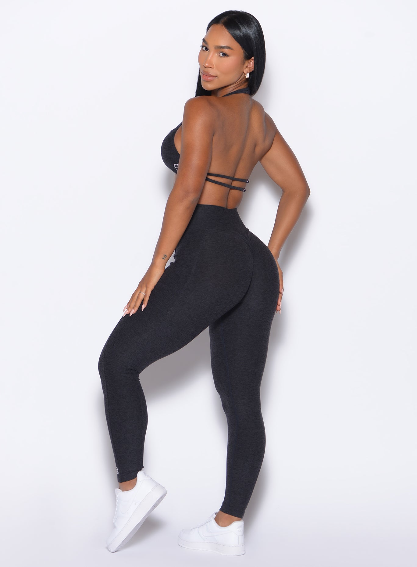 left side profile view of our model wearing the Curves 2.0 Leggings in Onyx color paired with the matching top