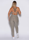 back profile view of a model in our curves leggings in nori color along with the matching bra