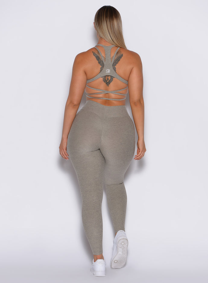 back profile view of a model wearing our curves leggings in nori color along with the matching sports bra