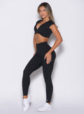 front left side profile view of a model wearing the Define Leggings in Black color