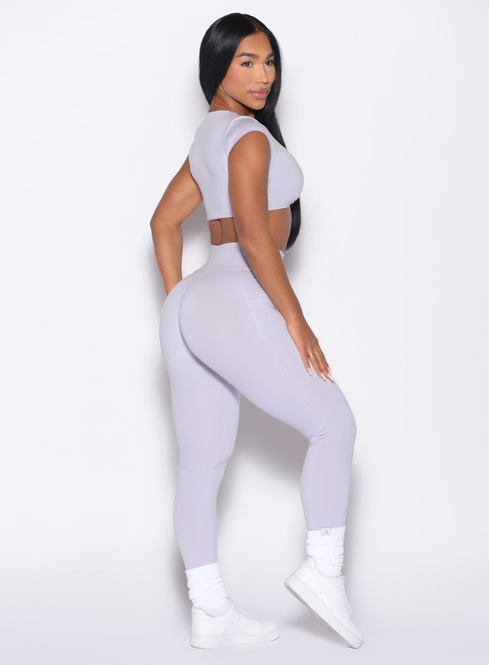 right side profile view of a model wearing the Define Leggings in Galactic Lilac color