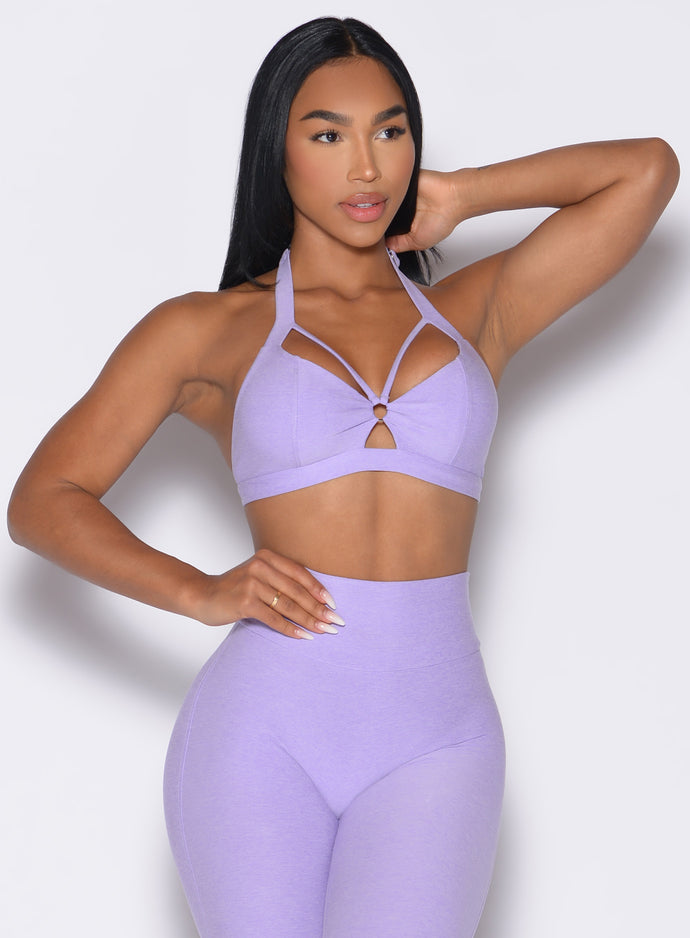 front profile view of a model with one hand on her waist wearing the Iron Edge Bra in Sugared Lilac color