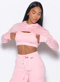 front profile view of a model wearing our Sweat Bolero Hoodie and the matching Joggers in Tickled Pink color