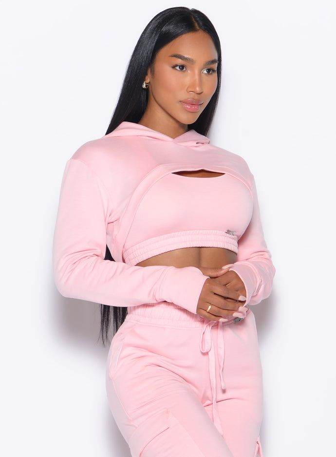 front profile picture of a model in our Sweat Bolero Hoodie and the matching Joggers in Tickled Pink color
