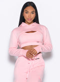 Model facing forward wearing our Sweat Bolero Hoodie and the matching Joggers in Tickled Pink color