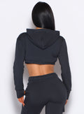 Back side close up view of model wearing the Sweat Bolero Hoodie and the matching Joggers in Vintage Black color
