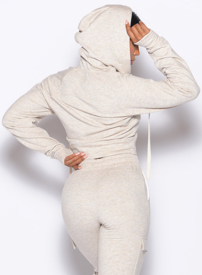 back profile view of a model in our Sweat Hoodie and the matching Joggers in Heathered Oatmeal color