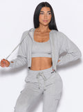 front profile view of our model pulling the hoodie string wearing the Sweat Hoodie in Light heather grey color