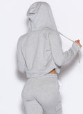 back profile view of our model with the hoodie cap on wearing the Sweat Hoodie in Light heather grey color