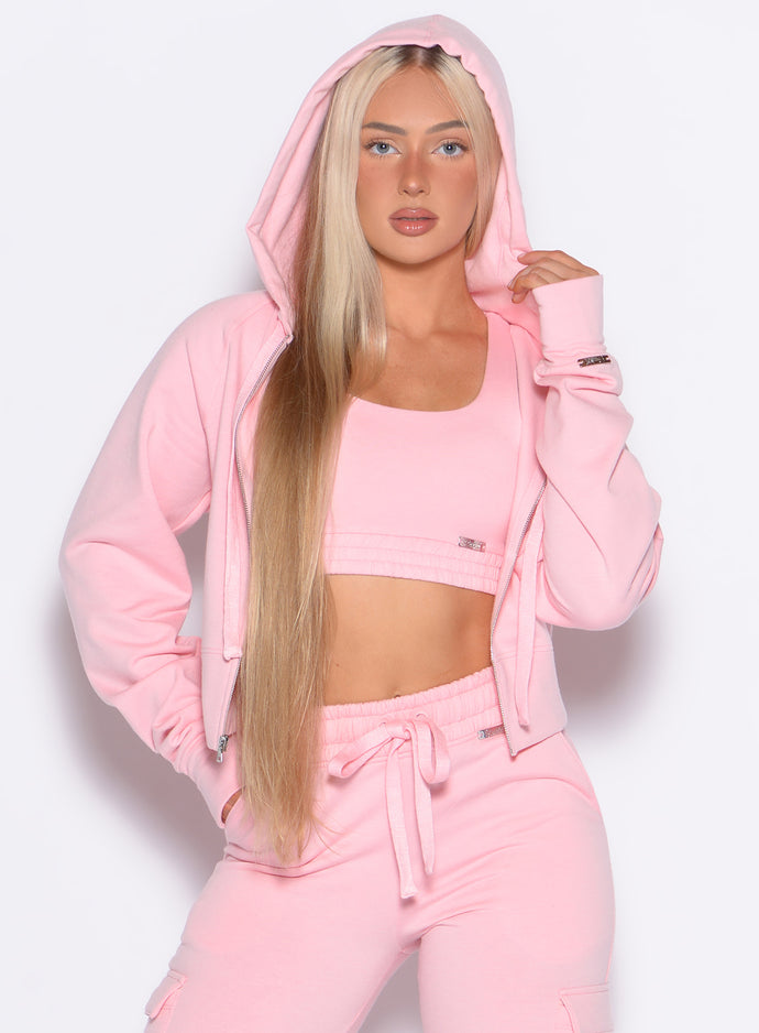 front profile view of our model with the hoodie cap on wearing the Sweat Hoodie in tickled pink color