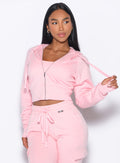 front profile view of our model looking to the left wearing the Sweat Hoodie in tickled pink color