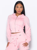 front profile view of our model with the hoodie zipper closed wearing the Sweat Hoodie in tickled pink color