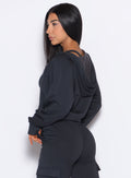 Left side view of model wearing the Sweat Hoodie and the matching Joggers in Vintage Black color