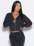 front profile view of a model wearing our Sweat Hoodie and the matching Joggers in Vintage Black color