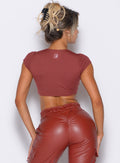 back profile view of our model wearing the Fab Bust Bra in brick red color