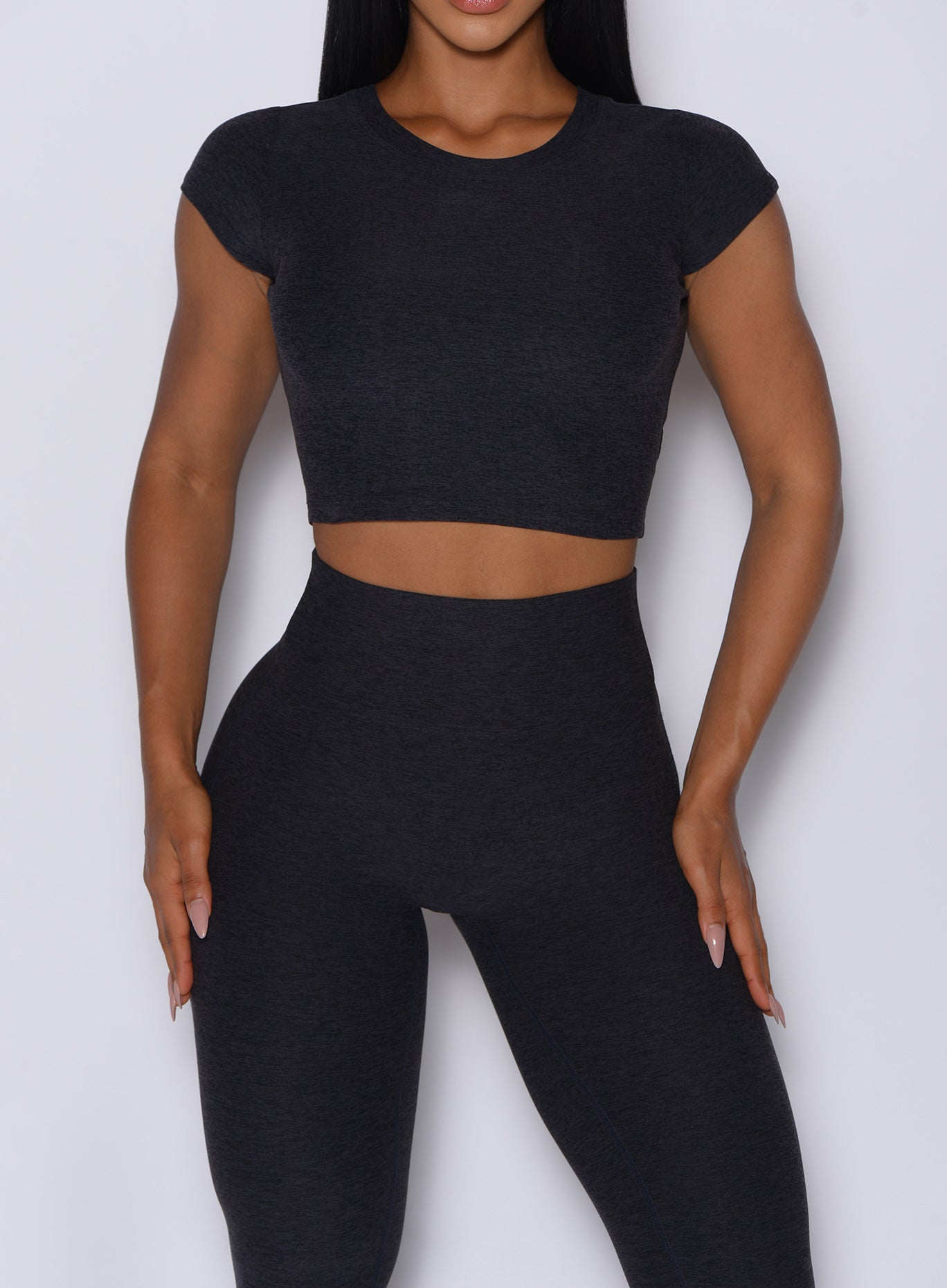 Zoomed in front view of our Fit Fam Active Tee in Onyx color along with the matching Leggings