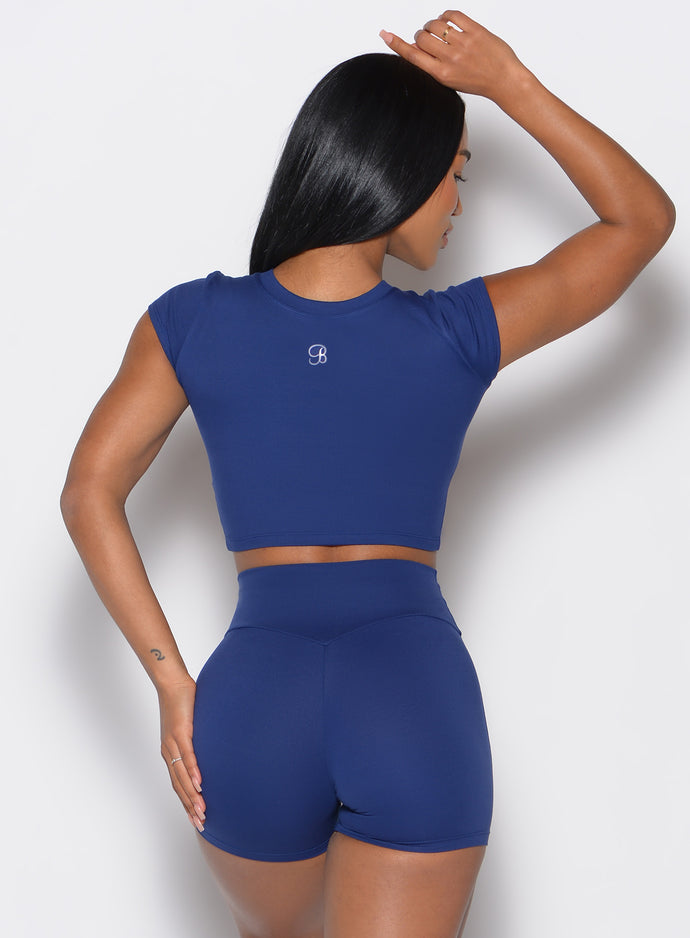 back profile of a model wearing the Fit Fam Active Tee and the matching shorts in Royal Indigo color