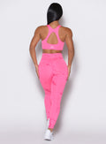 back profile view of a model wearing our fit marble leggings in Cotton Candy Skies color along with a matching bra