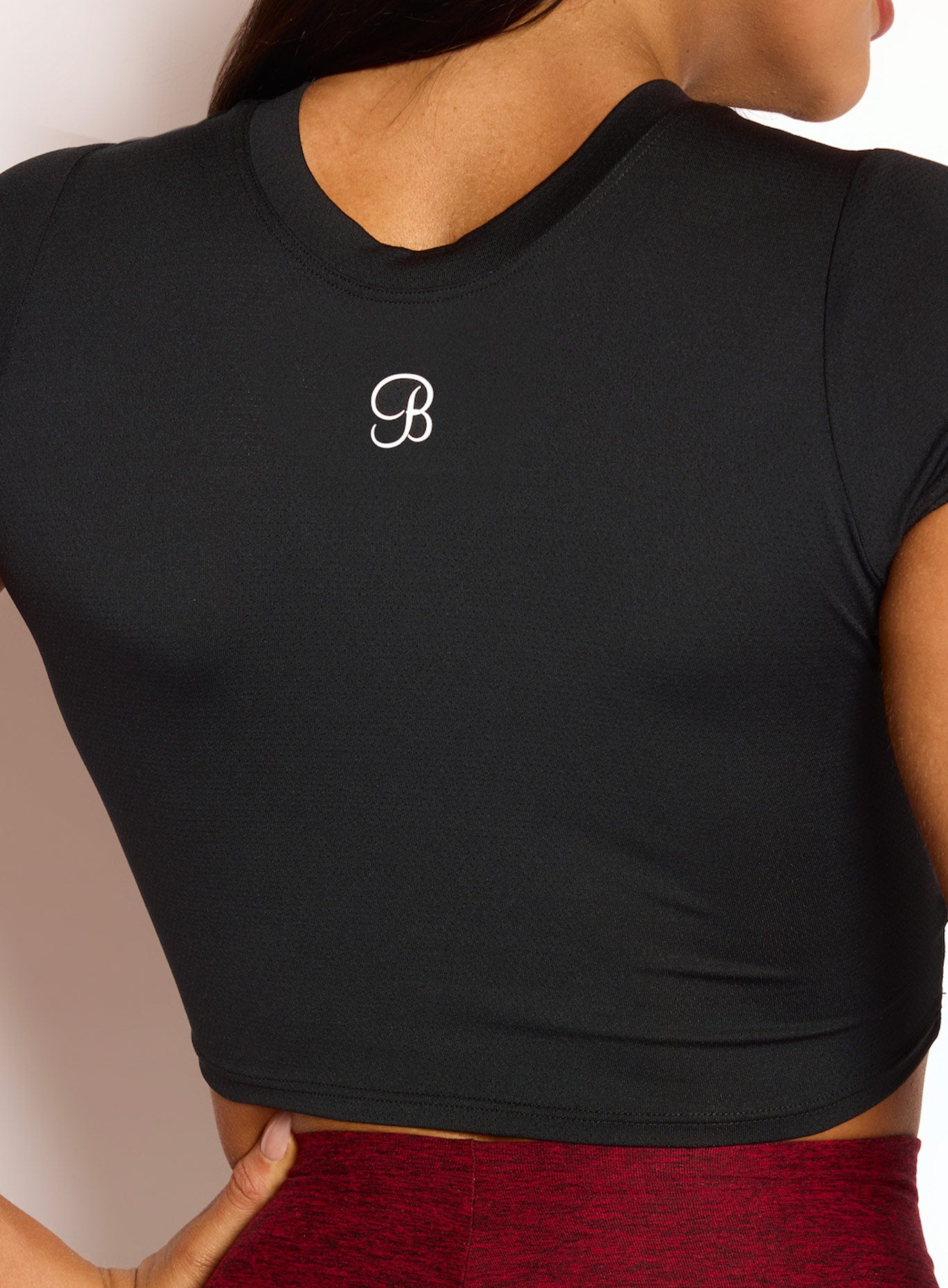 Back side close up view of model wearing our Flex Crop Tee in Black color
