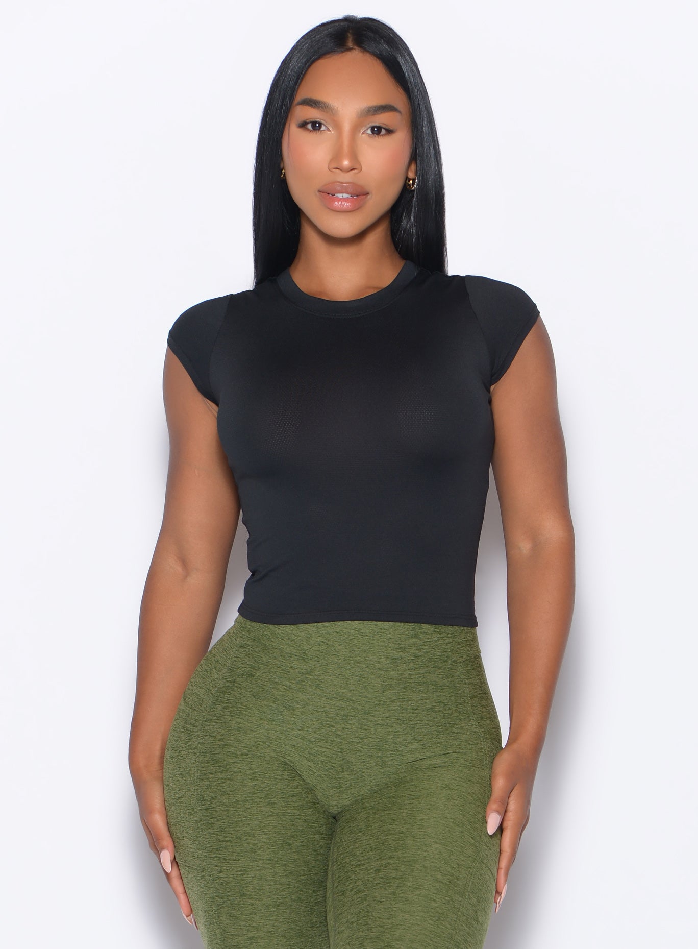 front profile view of a model wearing our Flex Long Tee in Black color and the Curves 2.0 Leggings in Juniper color
