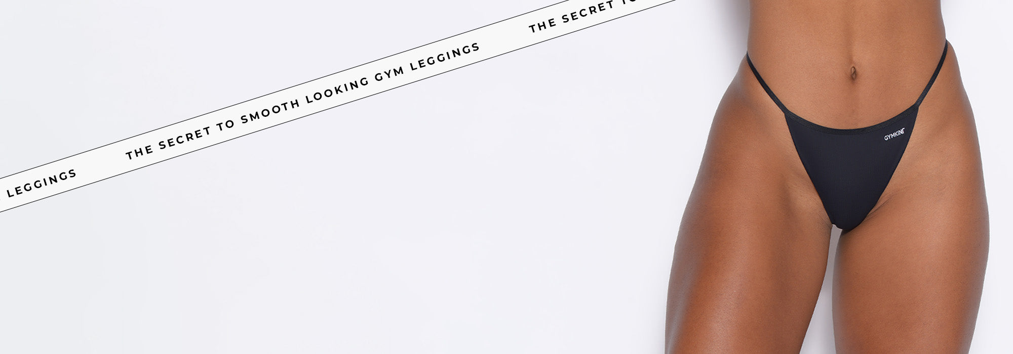 right profile view of model wearing black gymkini underwear with text that says "the secret to smooth looking gym leggings"